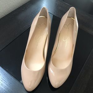 Nude patent pumps